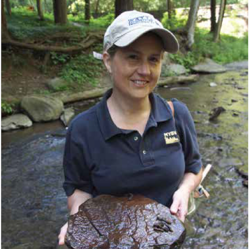 Ginger Ursitti Holds a rock with attached caddisfly casings.